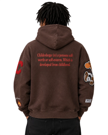 Brown hoodie with text and graphics on the back, worn by a person against a plain background