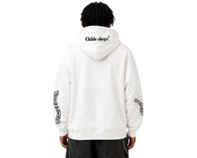 Person wearing a white hoodie with text and designs on sleeves against a gray background