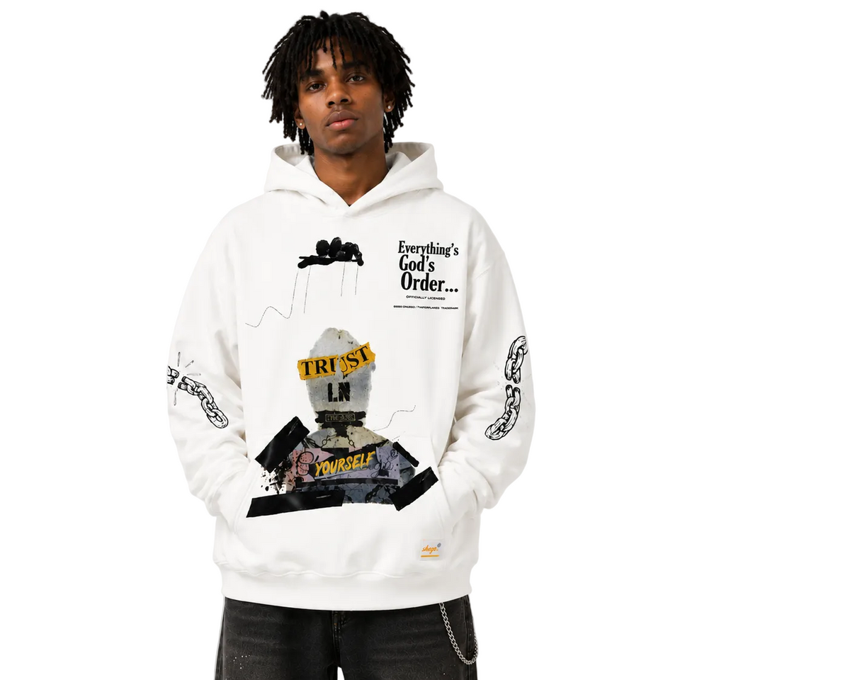 Person wearing a white hoodie with graphic designs and text on a plain background