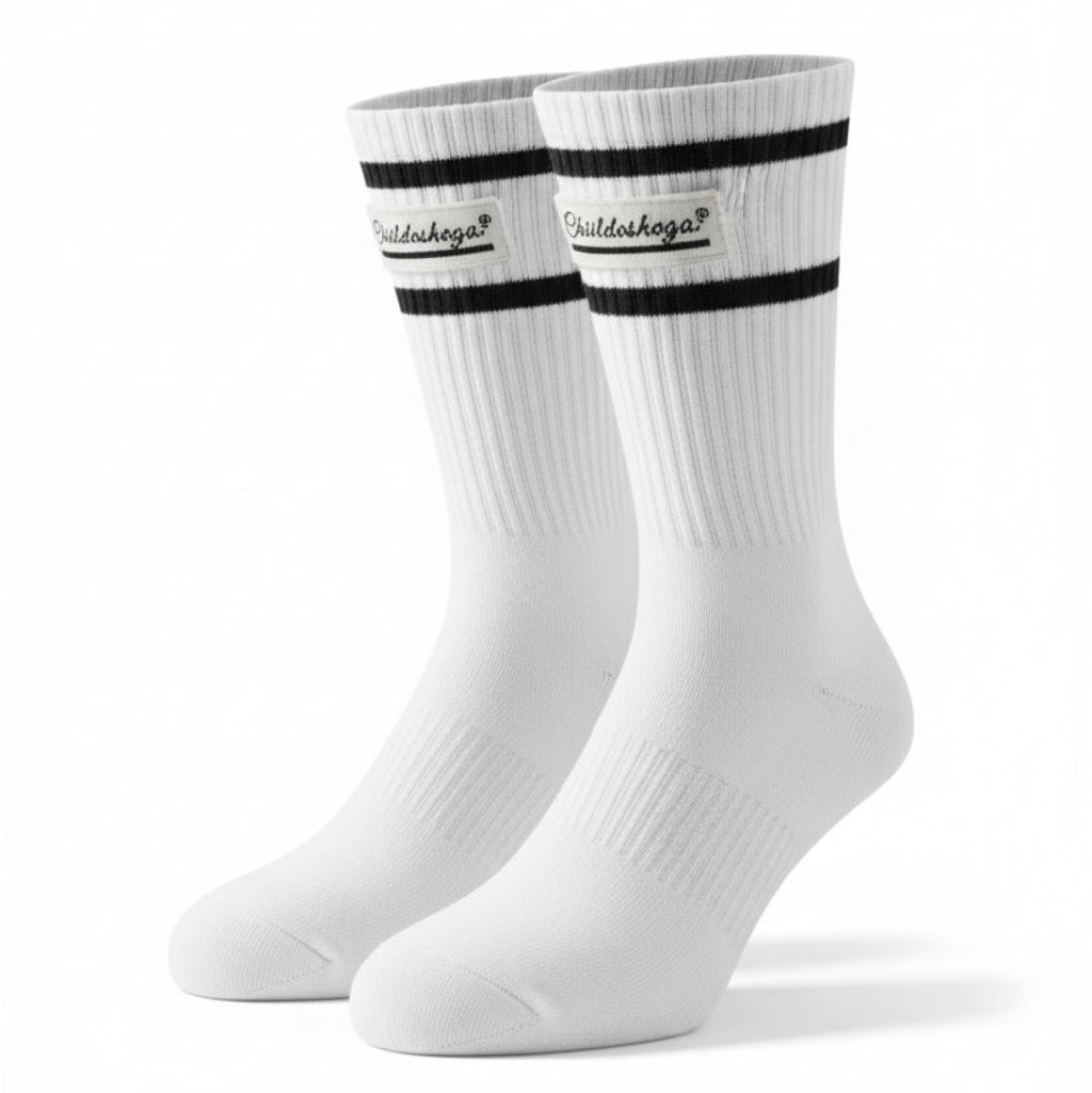 A pair of white crew socks with black stripes and a 'Chubbies' logo on the cuffs, laid flat on a black textured surface.