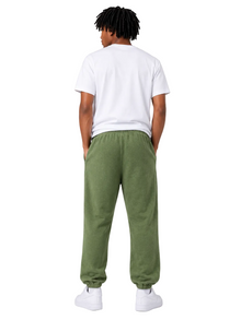 Person wearing a white t-shirt and green sweatpants on a plain background