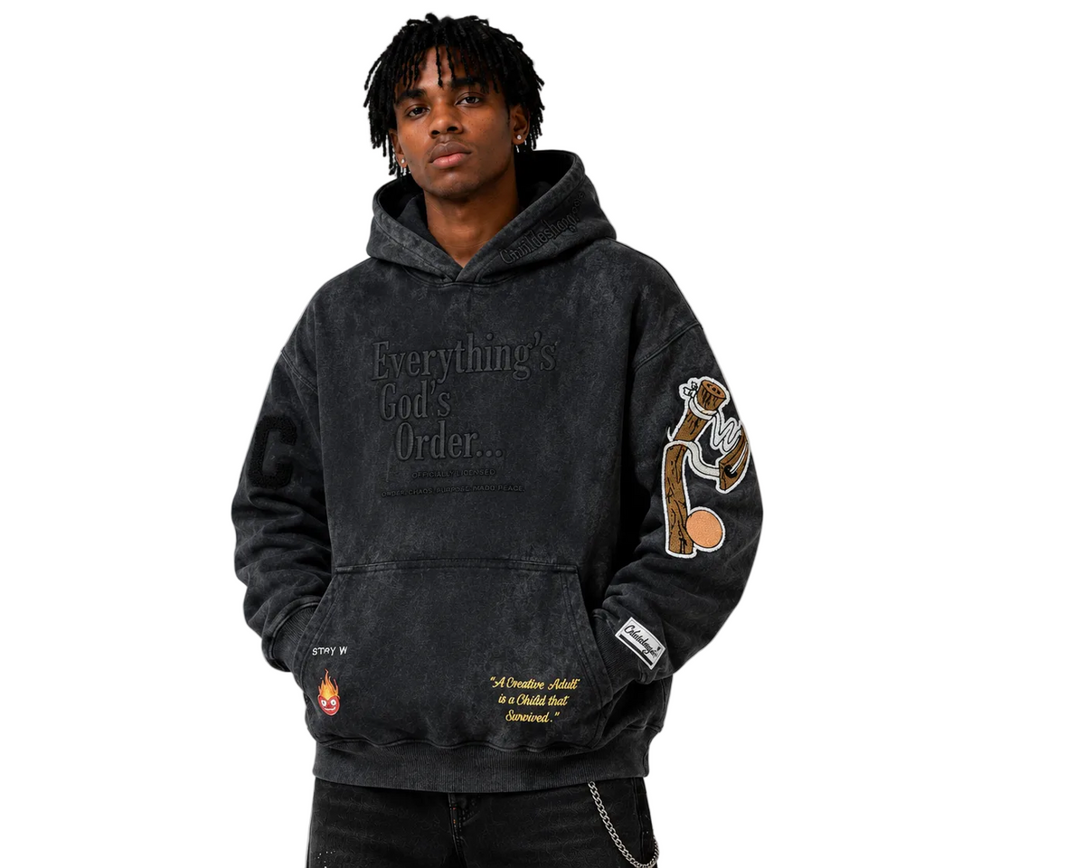 Person wearing a black hoodie with text and graphics on a gray background