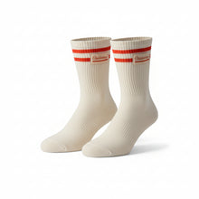 A pair of off-white athletic socks with two red stripes and a red logo on the cuffs, displayed on a solid white background.