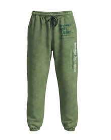 Green sweatpants with text on a light gray background